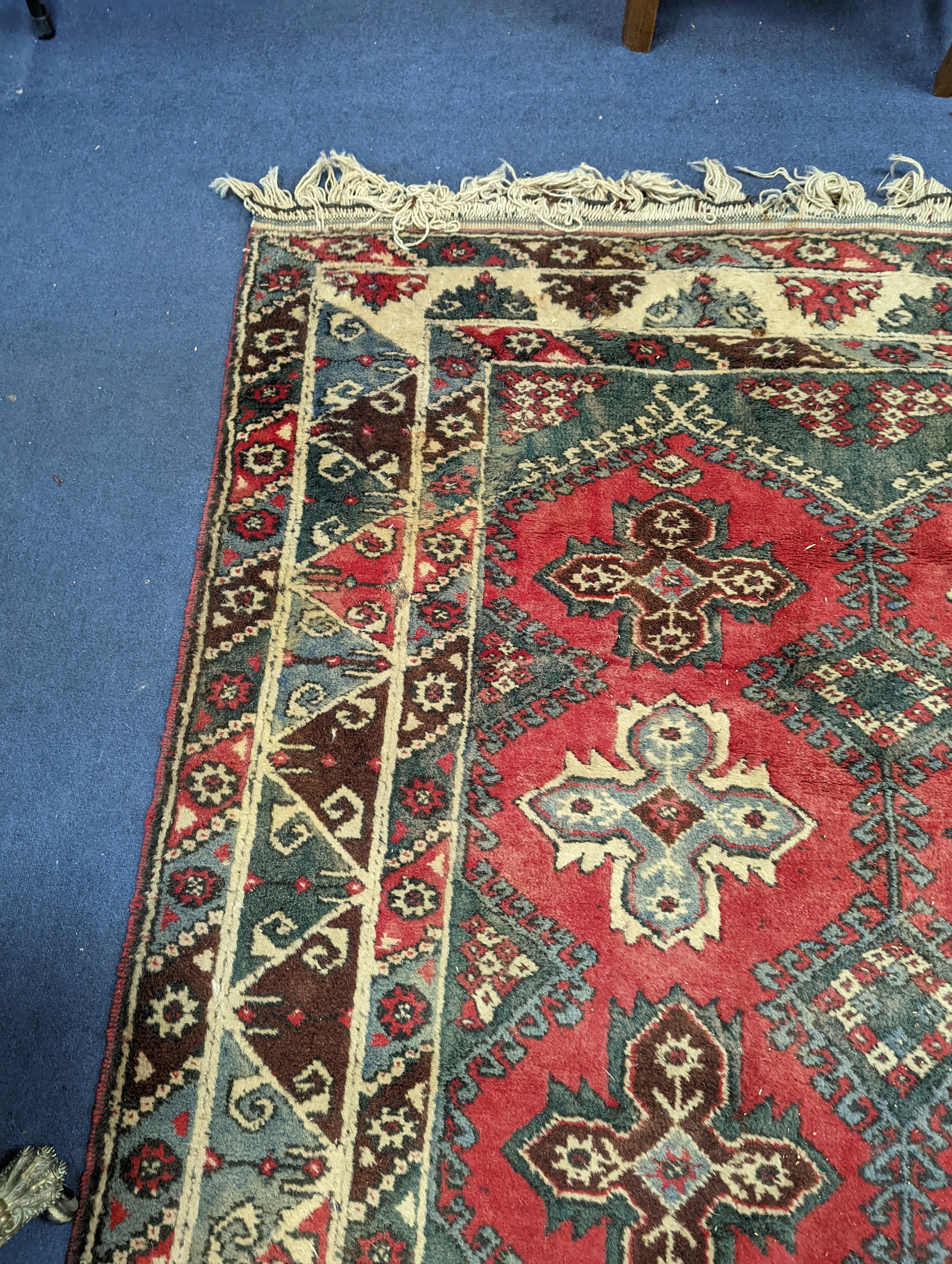 A Caucasian style red ground carpet, 286 x 210cm